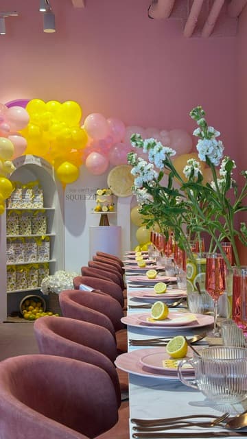 Private event with pink table setting and balloon decorations